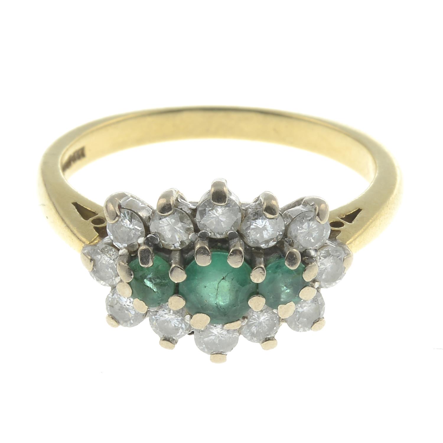 An 18ct gold emerald and diamond dress ring.Estimated total diamond weight 0.80ct.
