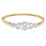 A 9ct gold diamond bangle.Total diamond weight 0.25ct, stamped to mount.