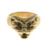 A stylised panther mask ring, with red gem eye detail.Stamped 9ct.Ring size R.