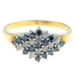 A 9ct gold diamond and colour-treated 'blue' diamond dress ring.Total diamond and colour-treated