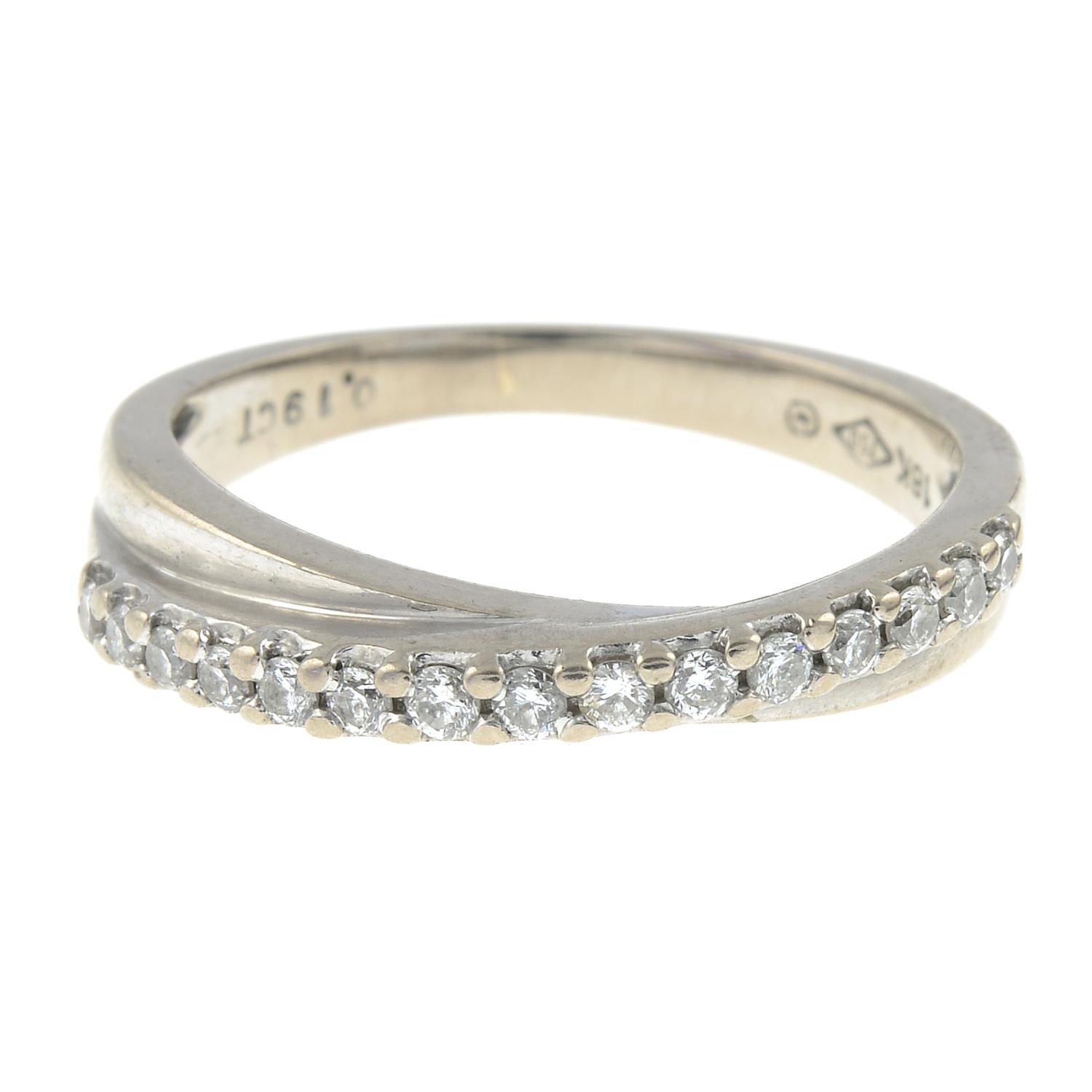 A brilliant-cut diamond line crossover ring.Total diamond weight 0.19ct,