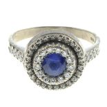 An 18ct gold sapphire and diamond cluster ring.Estimated total diamond weight 0.20ct.Hallmarks for