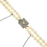 A cultured pearl two-row necklace, with diamond clasp.Cultured pearls measuring 8.9 to 5.8mms.