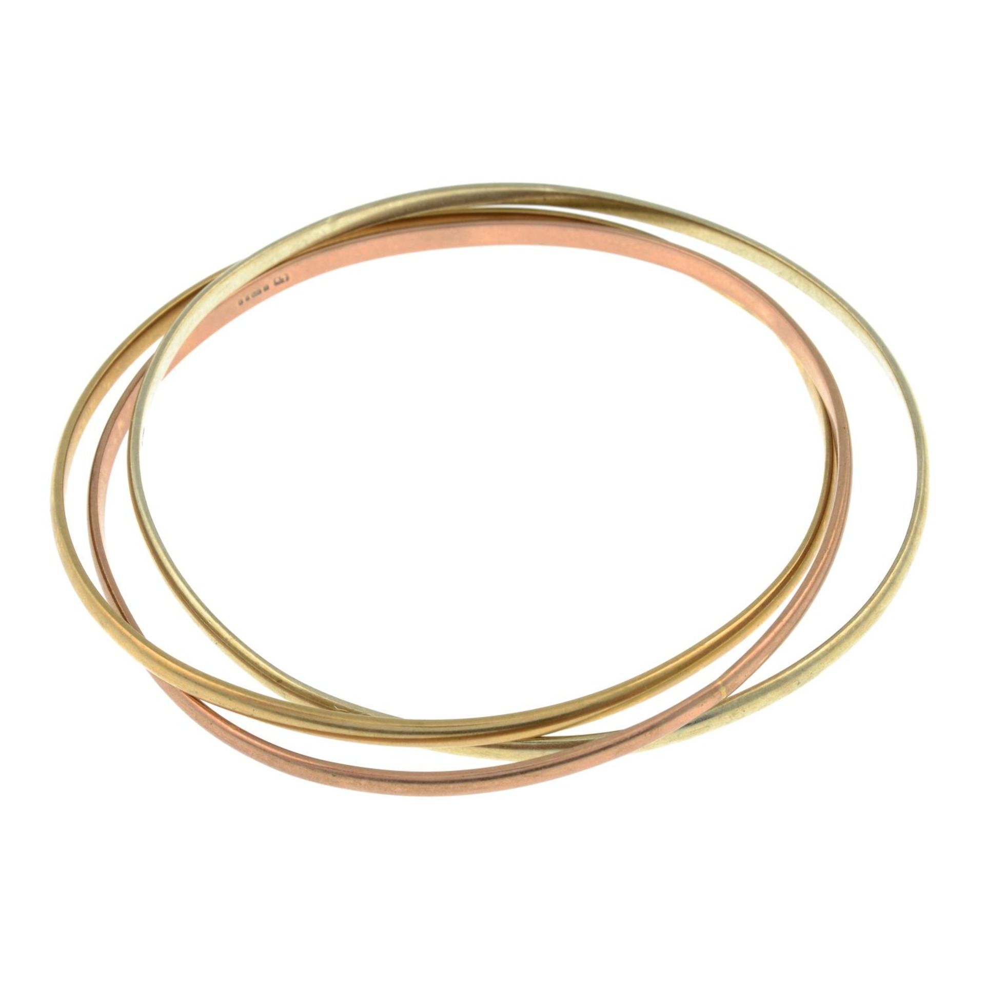 A 9ct gold tri-colour three-band bangle.Hallmarks for 9ct gold.