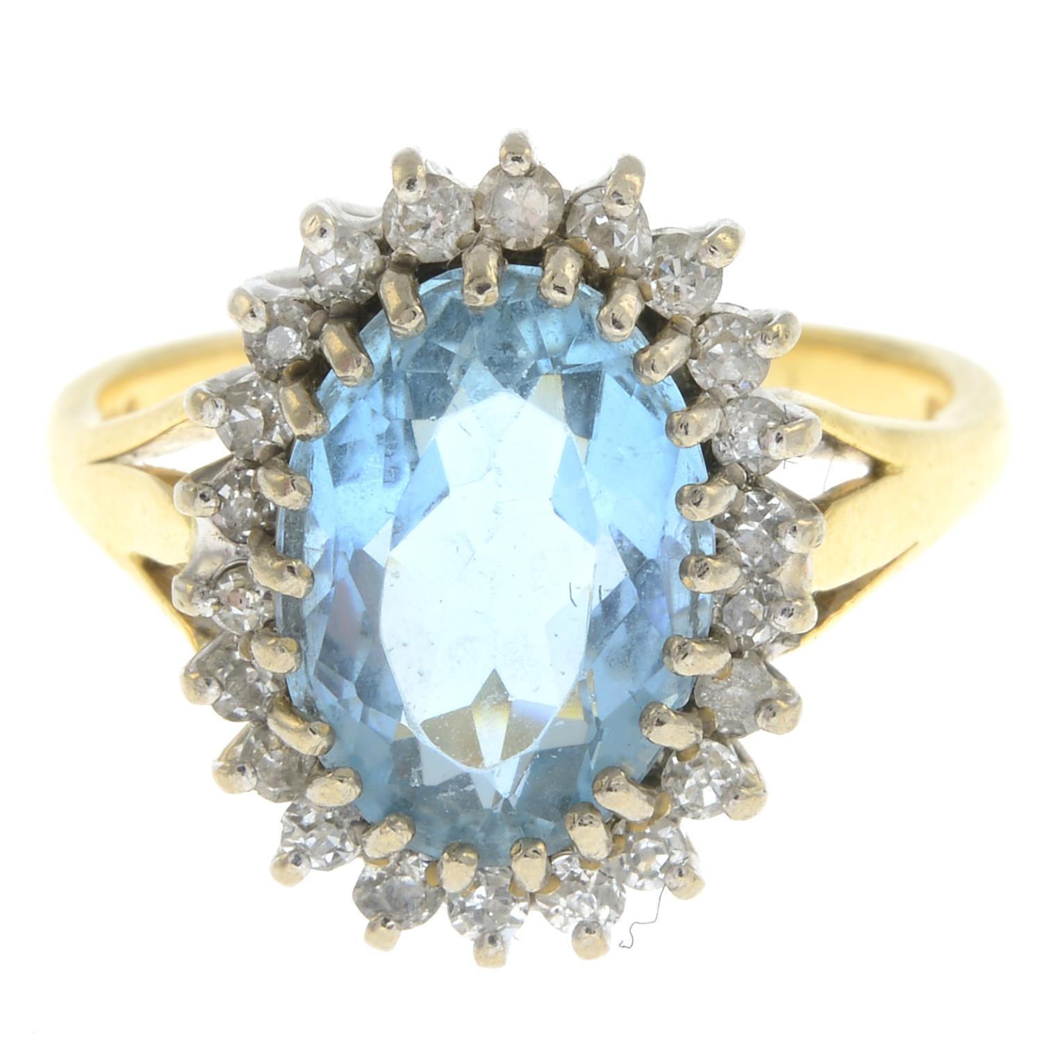 An 18ct gold blue topaz and old-cut diamond cluster ring.Topaz calculated weight 4.07cts ,