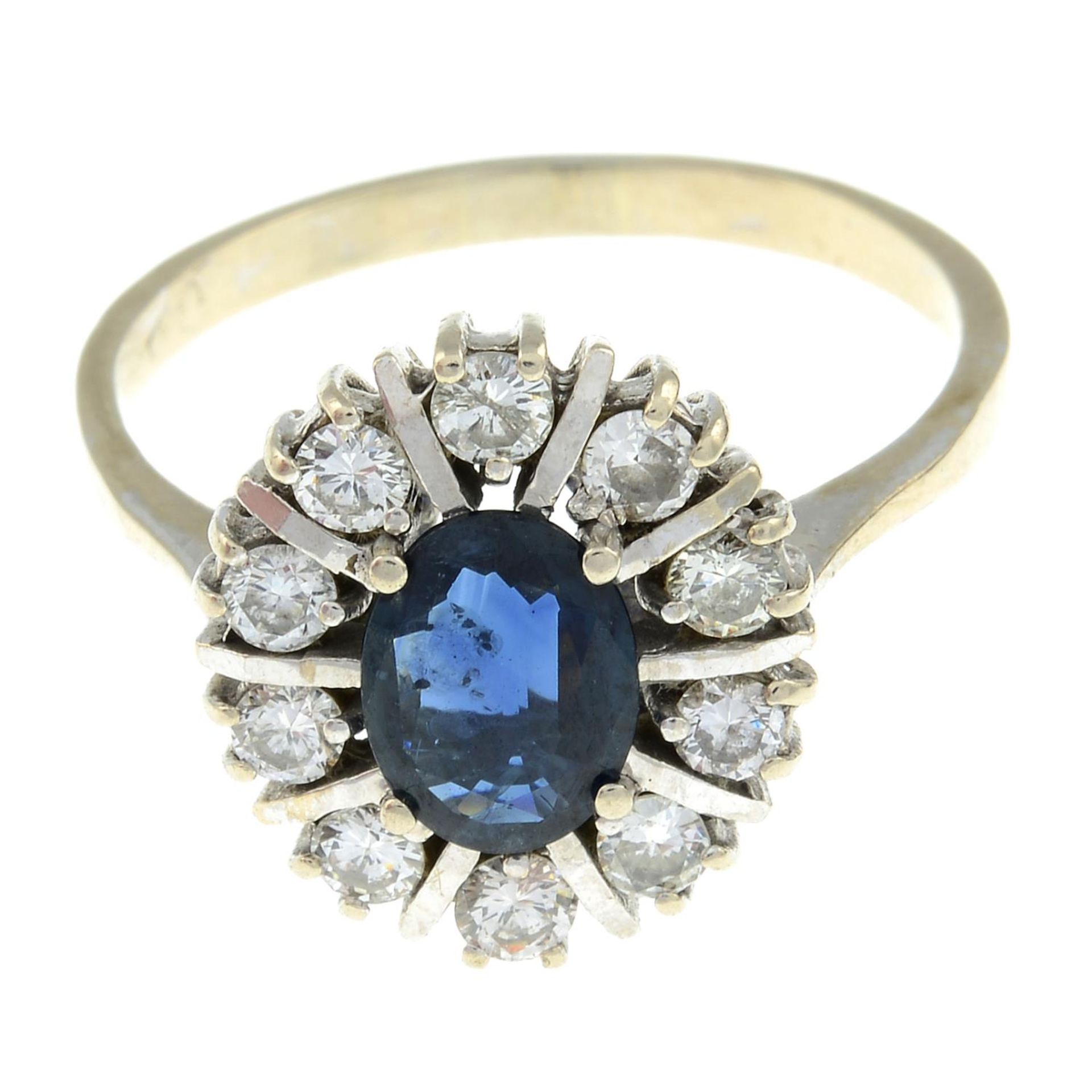 A sapphire and brilliant-cut diamond cluster ring.Estimated total diamond weight 0.40ct.Stamped