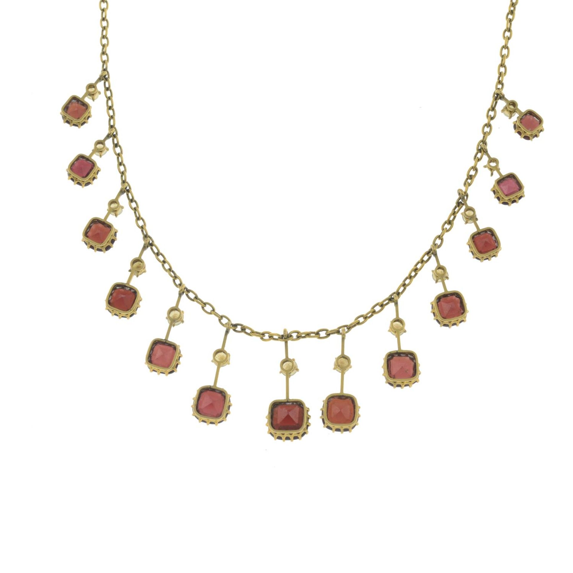 An early 20th century 9ct gold garnet and slit pearl fringe necklace.One split pearl deficient. - Image 3 of 3