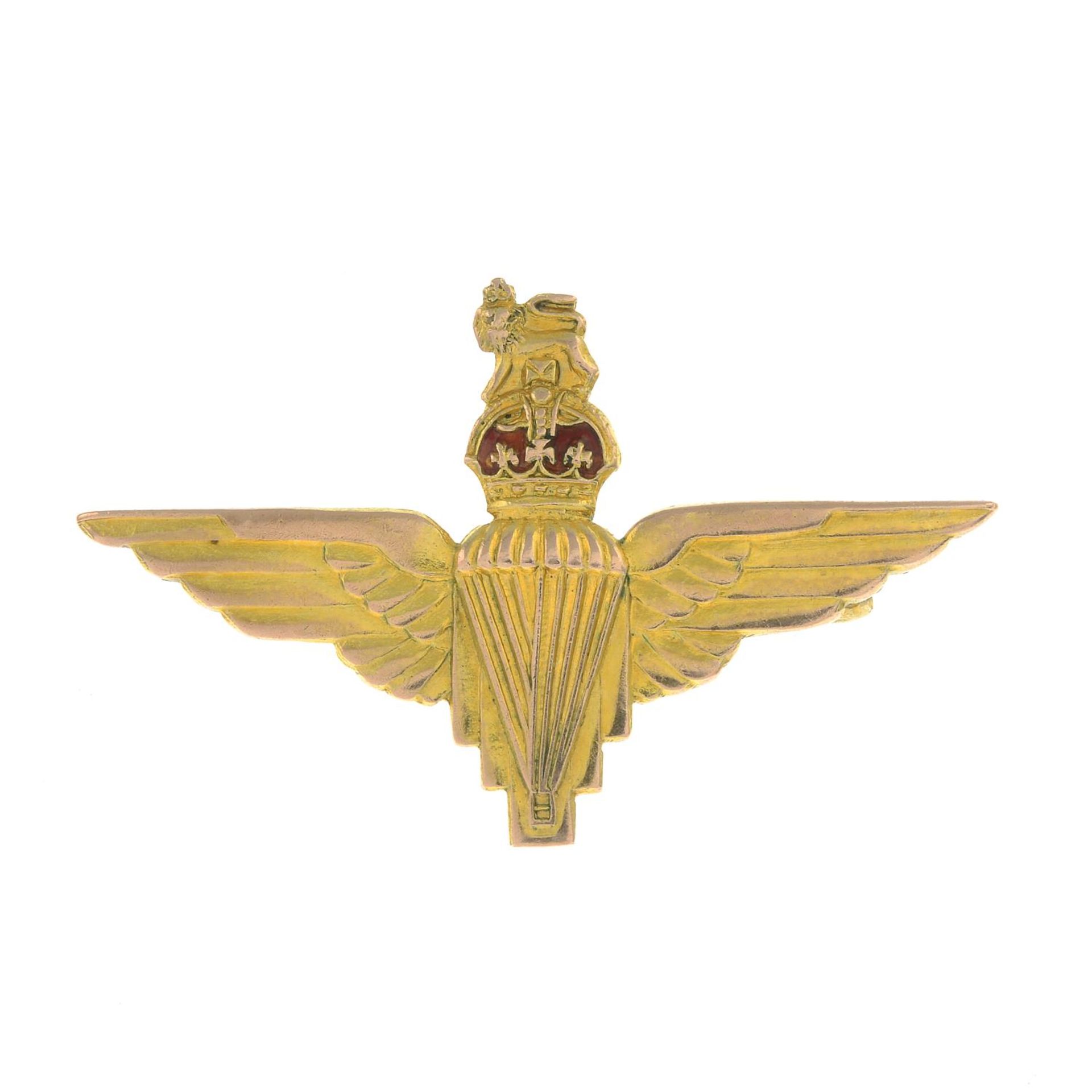 A 1950s 9ct gold Parachute Regiment brooch, with red enamel accent.Hallmarks for Birmingham, 1959.
