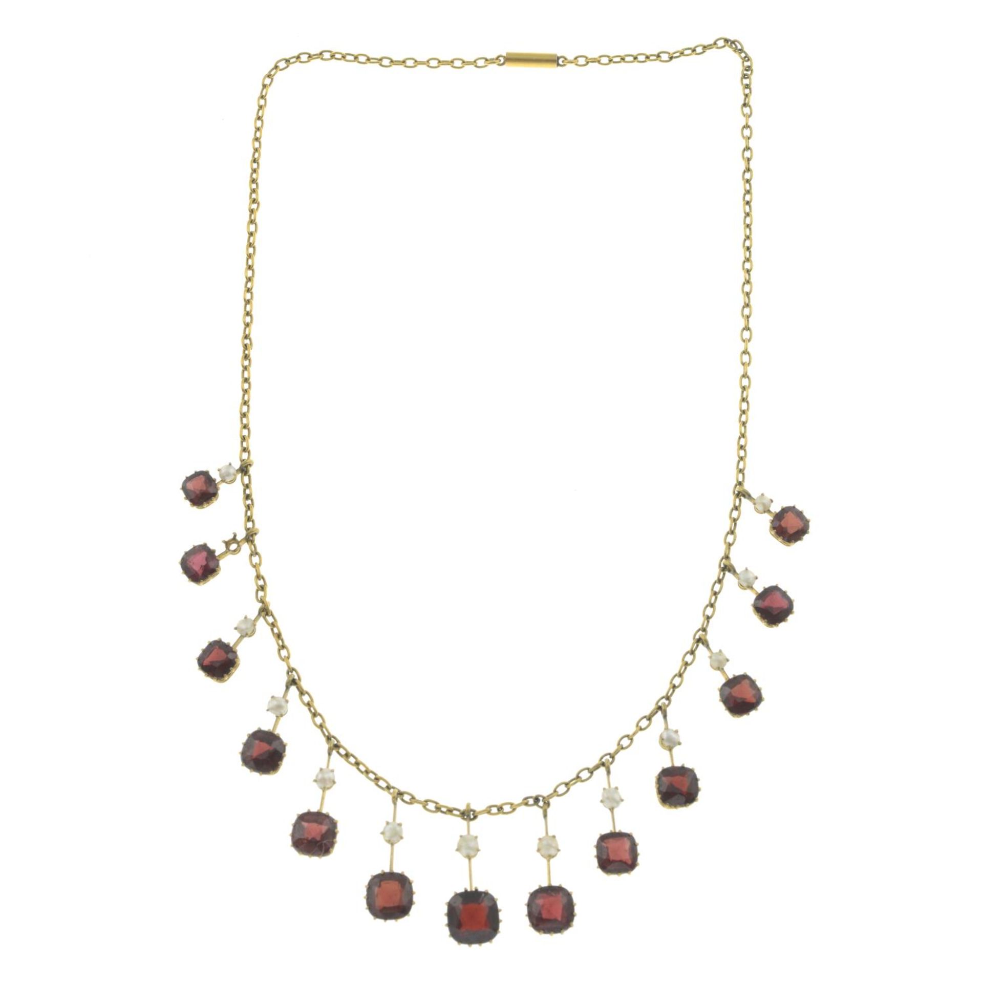 An early 20th century 9ct gold garnet and slit pearl fringe necklace.One split pearl deficient. - Image 2 of 3