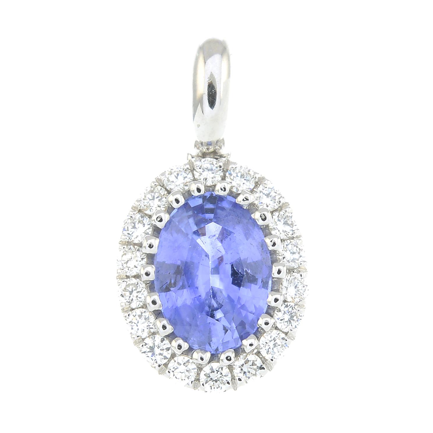 A diamond and sapphire cluster pendant.Sapphire weight 0.89ct.
