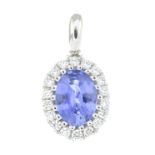 A diamond and sapphire cluster pendant.Sapphire weight 0.89ct.