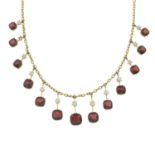 An early 20th century 9ct gold garnet and slit pearl fringe necklace.One split pearl deficient.