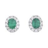 A pair of 18ct gold emerald and diamond cluster earrings.Estimated total diamond weight 0.10ct.