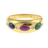 An emerald, ruby and sapphire ring, with diamond spacers.Stamped 750.