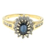 An 18ct gold sapphire and diamond cluster ring.Total diamond weight 0.33ct,