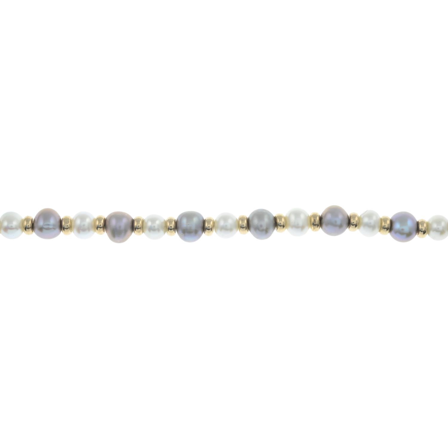 A cultured pearl bracelet, with polished bead spacers.Clasp stamped 9K 375.