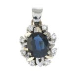 A sapphire and diamond pendant.Stamped 585.Length 1.8cms.