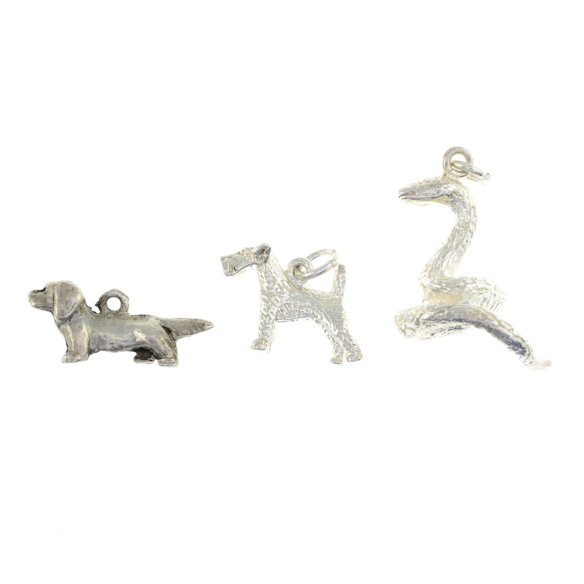 A selection of charms, to include a charm of a Sussex spaniel, a snake and a box terrier.