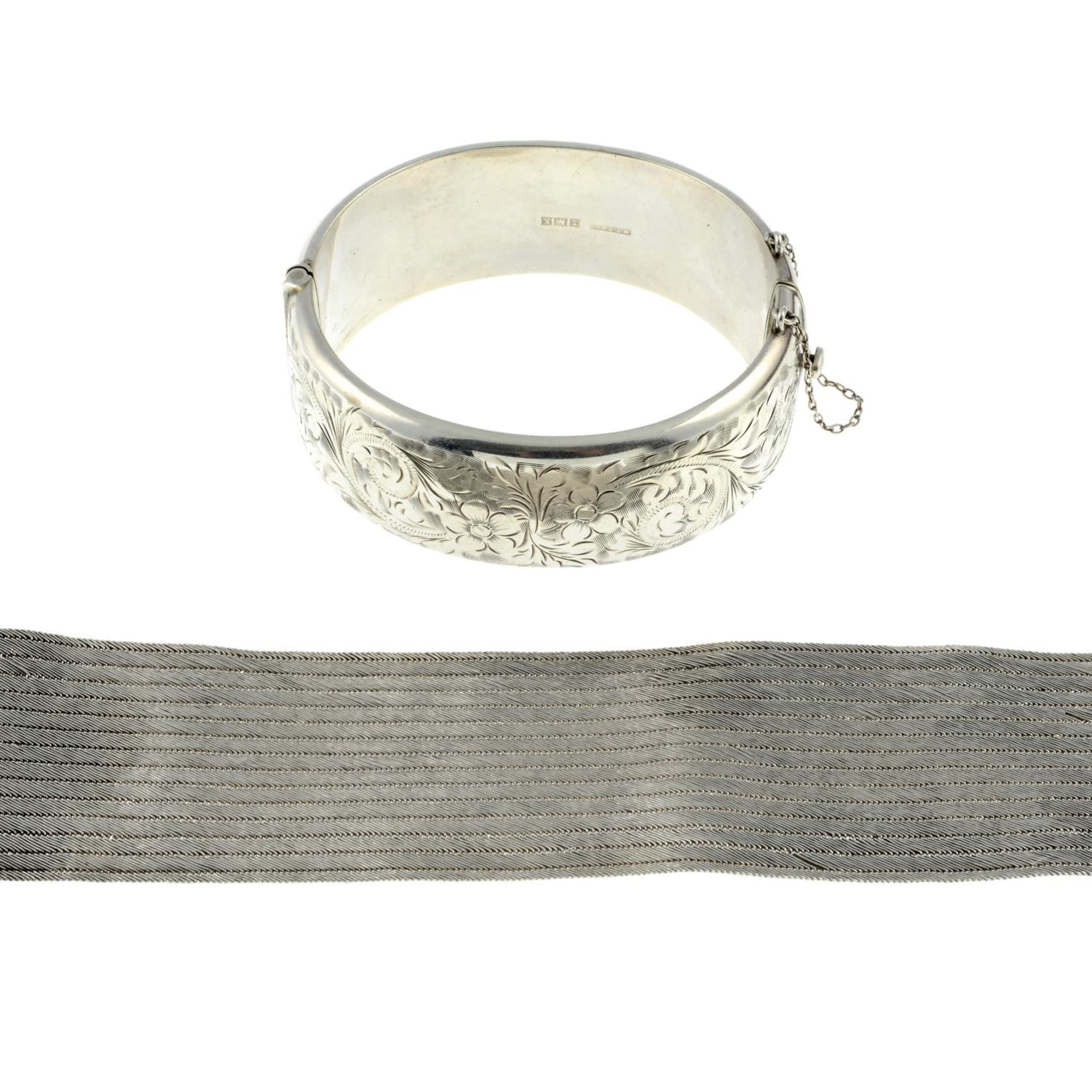 A silver bangle and a bracelet.