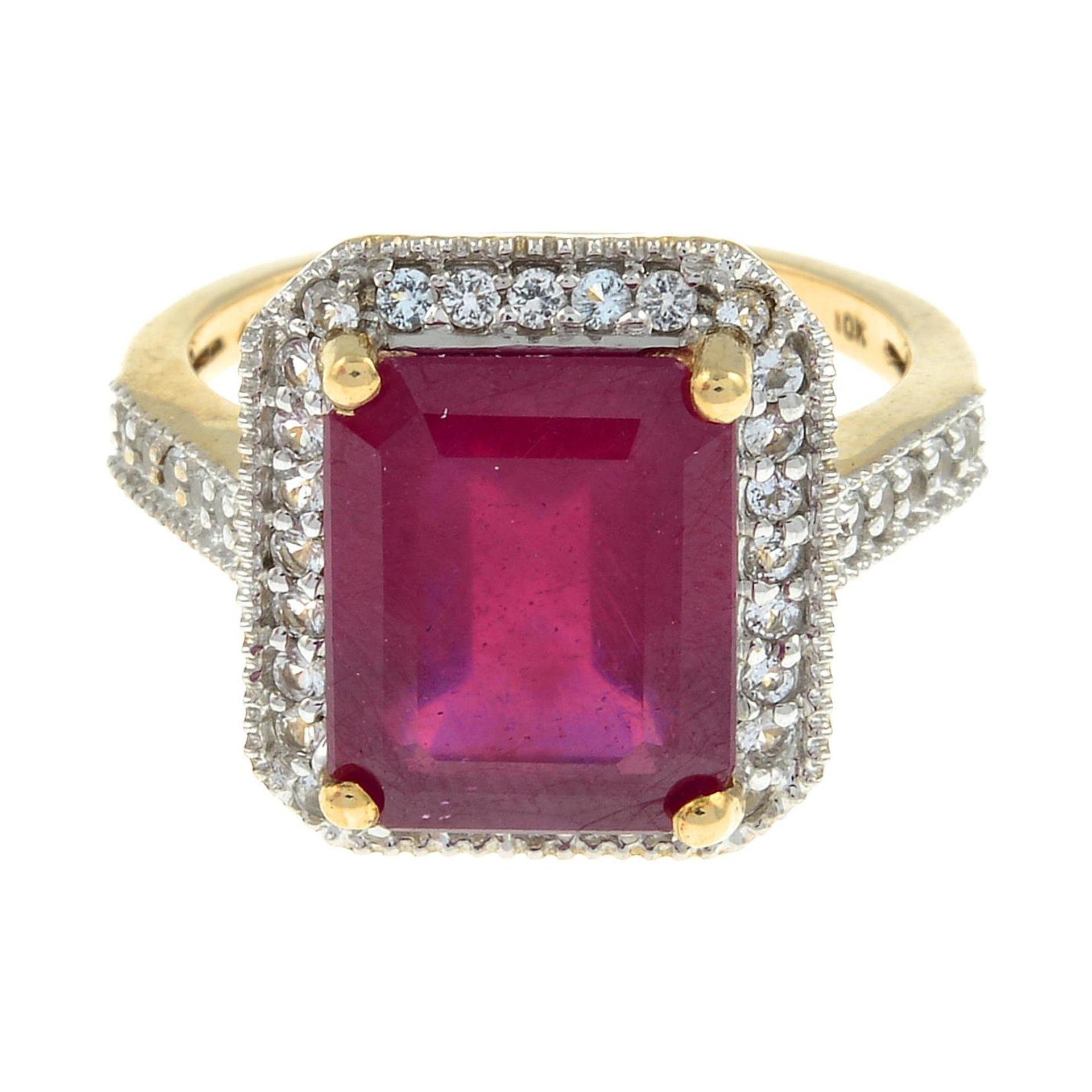 A 9ct gold ruby and colourless sapphire cluster ring.Ruby is glass-filled.