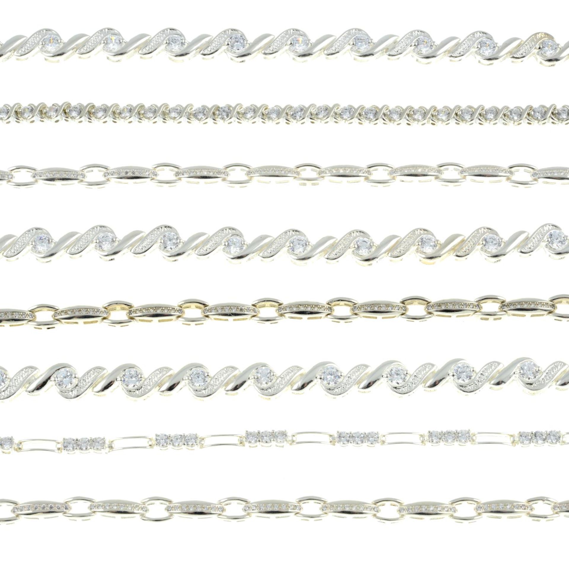 Eight cubic zirconia line bracelets.