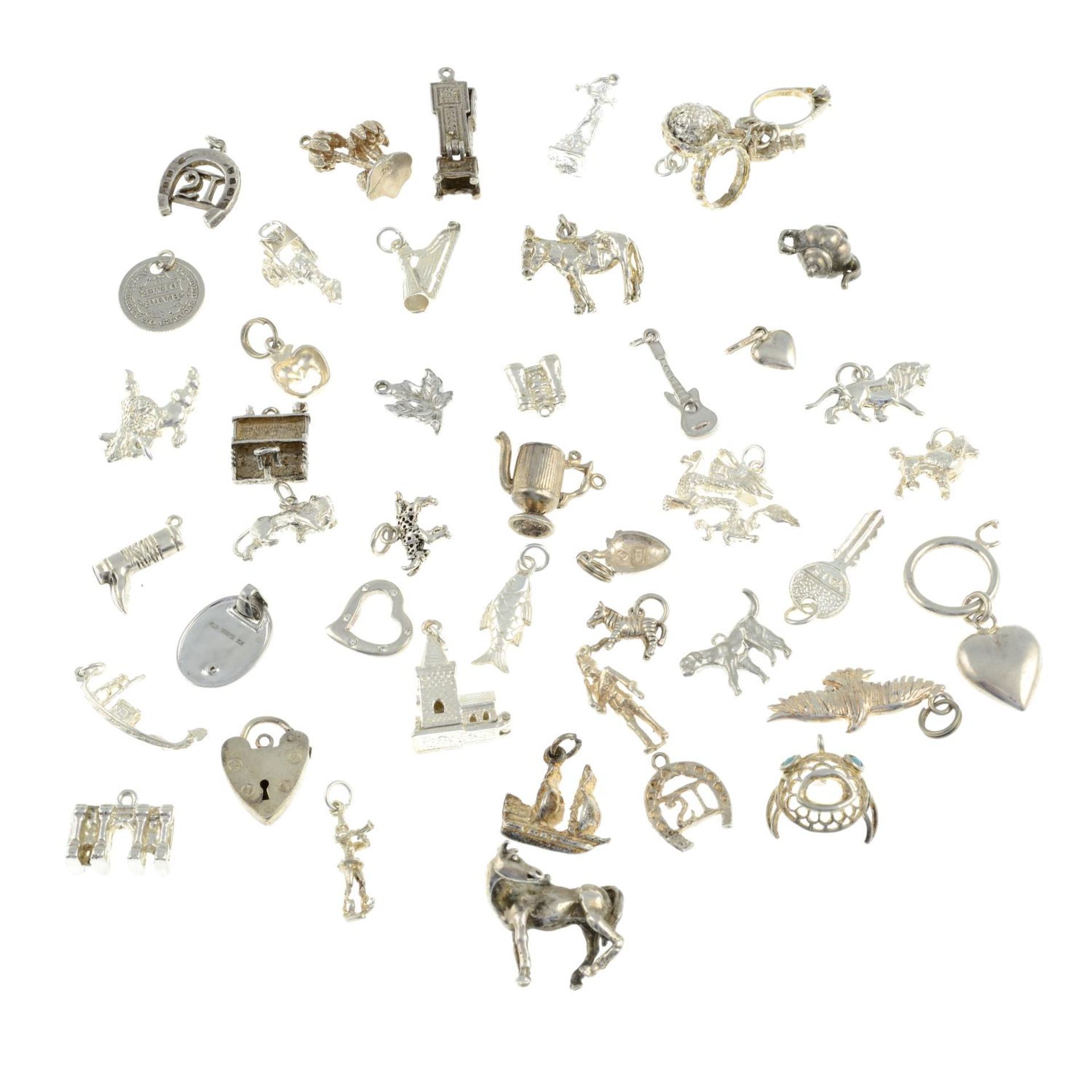 A selection of charms, to include a charm of a tankard, a chatelaine and a lion. - Image 2 of 2