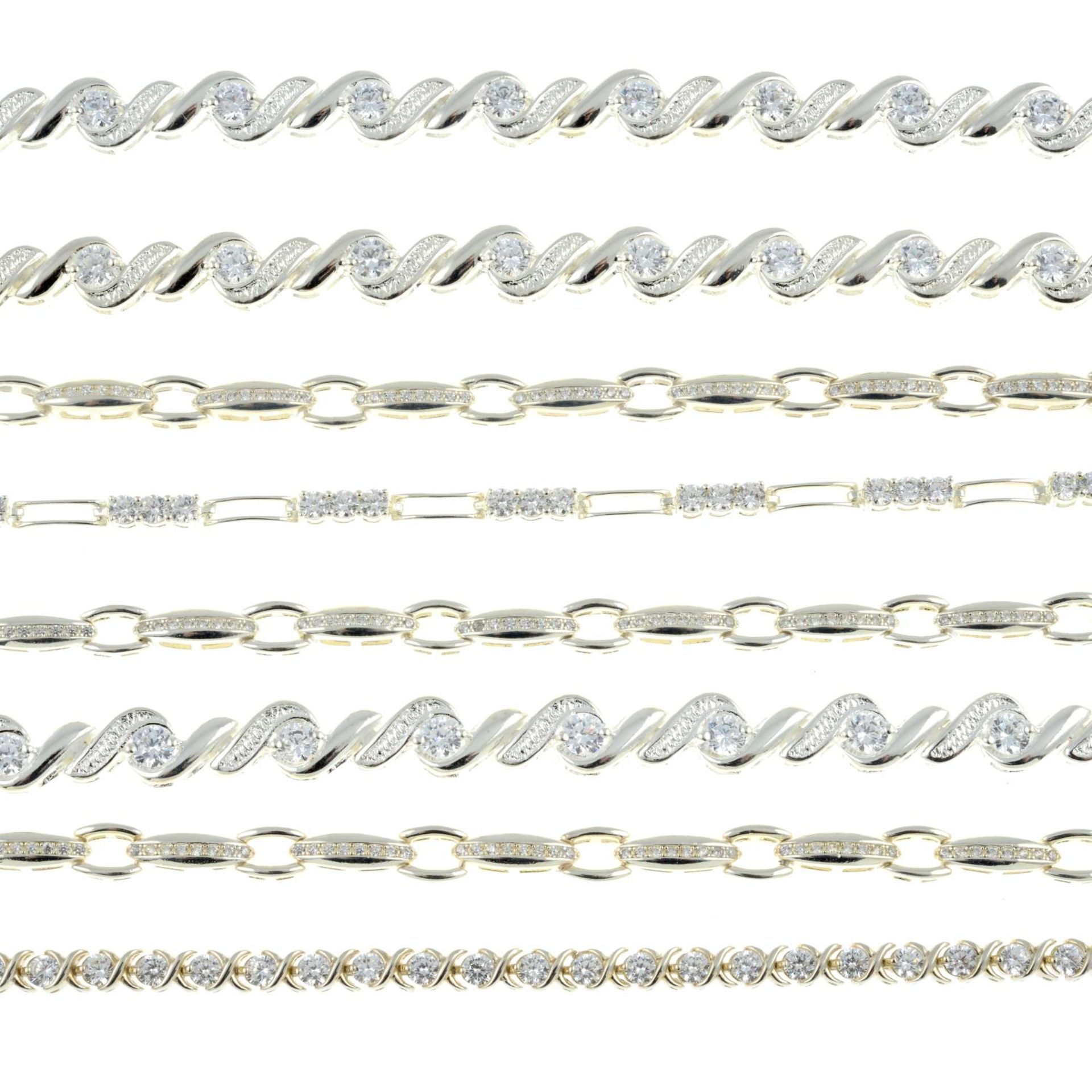 Eight cubic zirconia line bracelets.