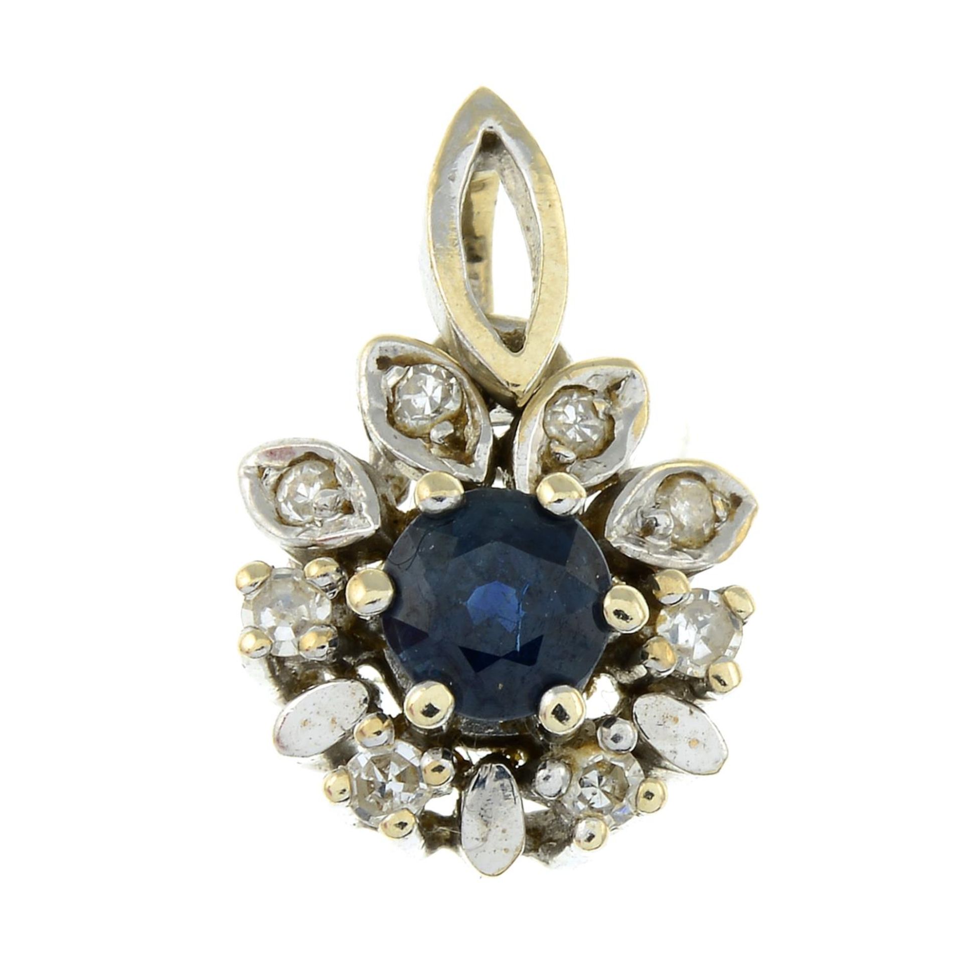 A sapphire and diamond pendant.Stamped 585.Length 1.7cms.