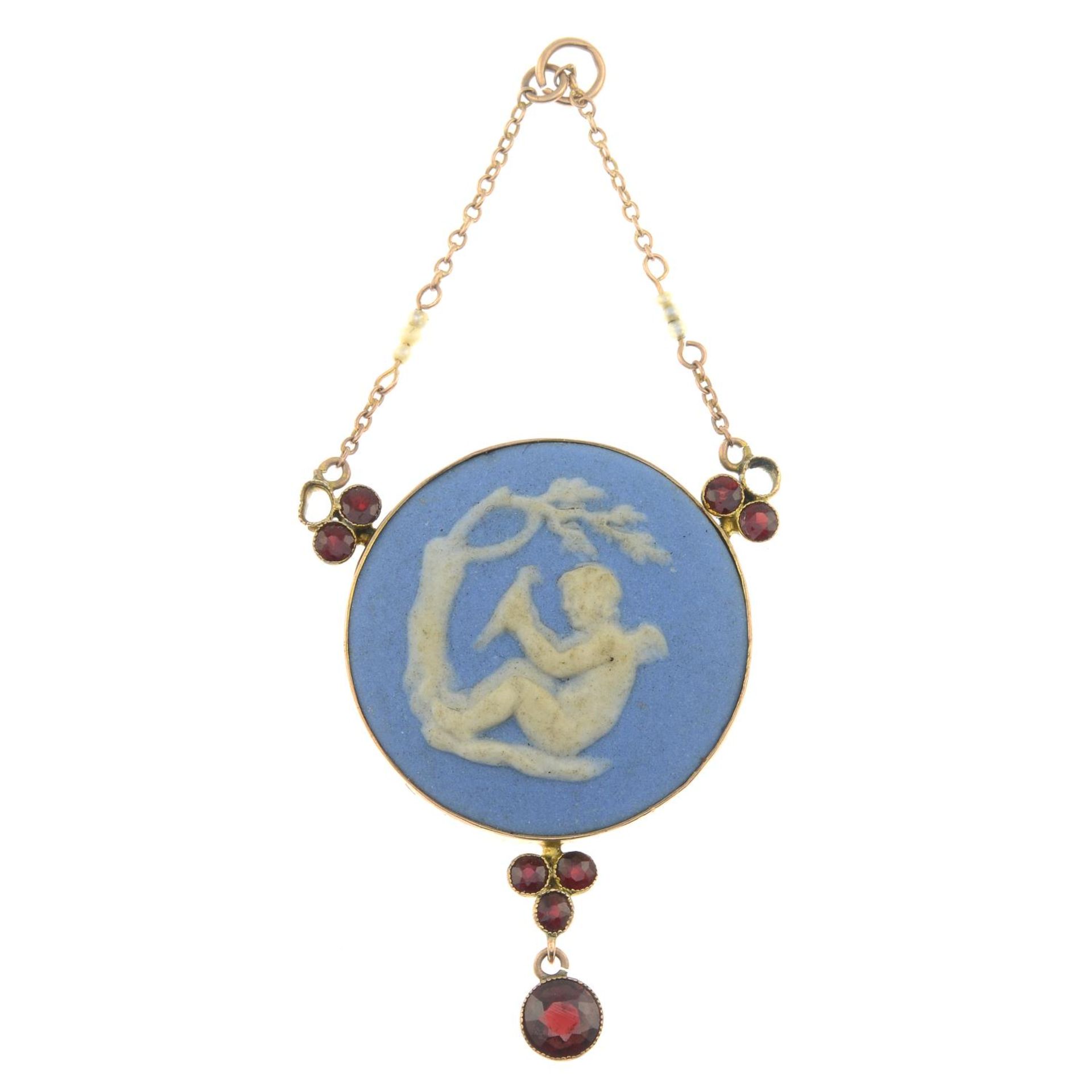 A 9ct gold Wedgwood cameo pendant with garnet and seed pearl detail.Signed Wedgwood.