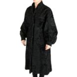 A knee-length Karakul wool coat.