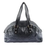 CHANEL - a quilted black leather Boston handbag.