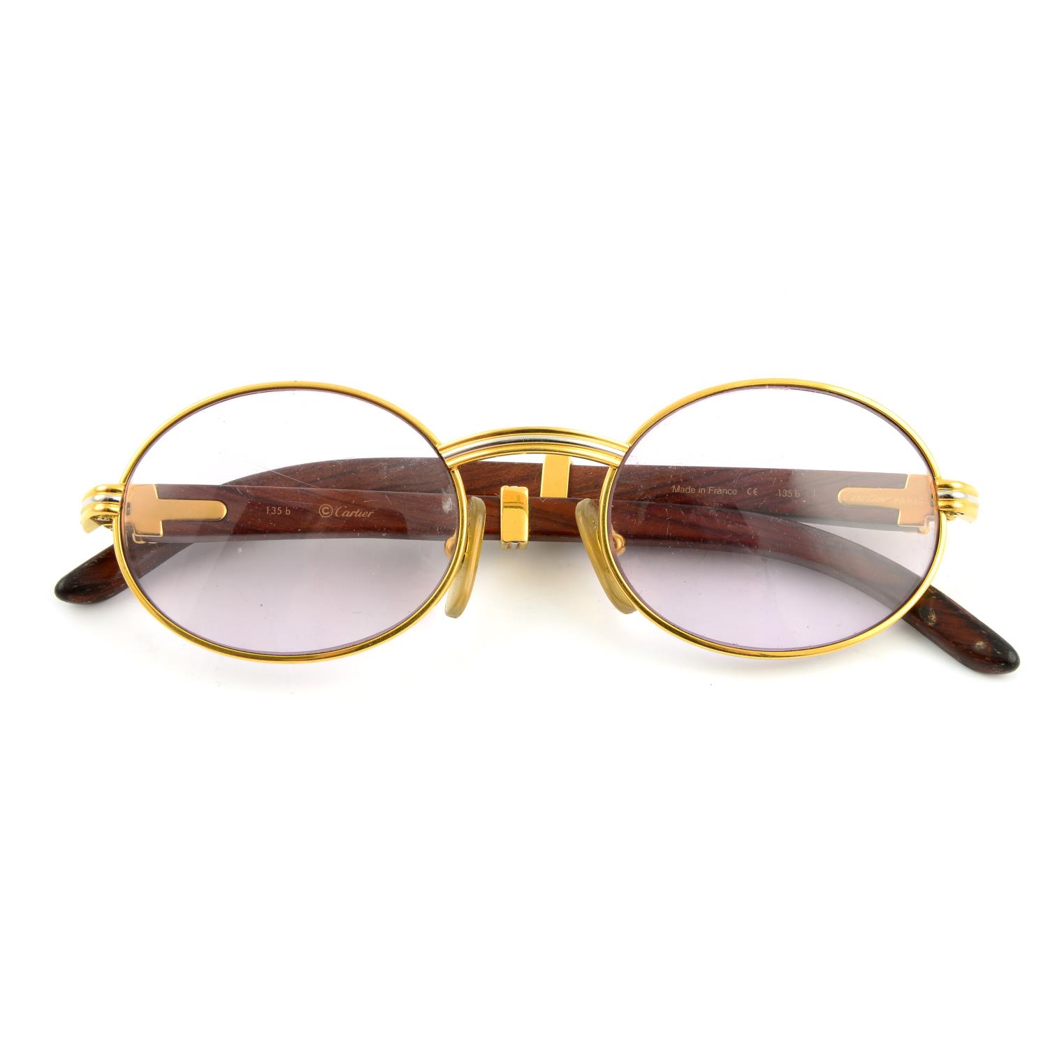 CARTIER - a pair of gold-plated prescription glasses.