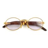 CARTIER - a pair of gold-plated prescription glasses.