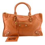 BALENCIAGA - an orange Giant Work handbag.