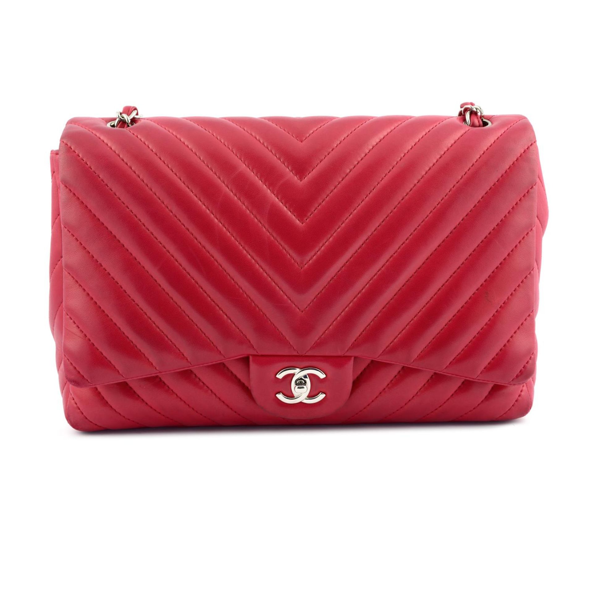 CHANEL - an amaranth red Maxi Classic Flap handbag.