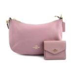 COACH - a pink leather handbag with matching purse.