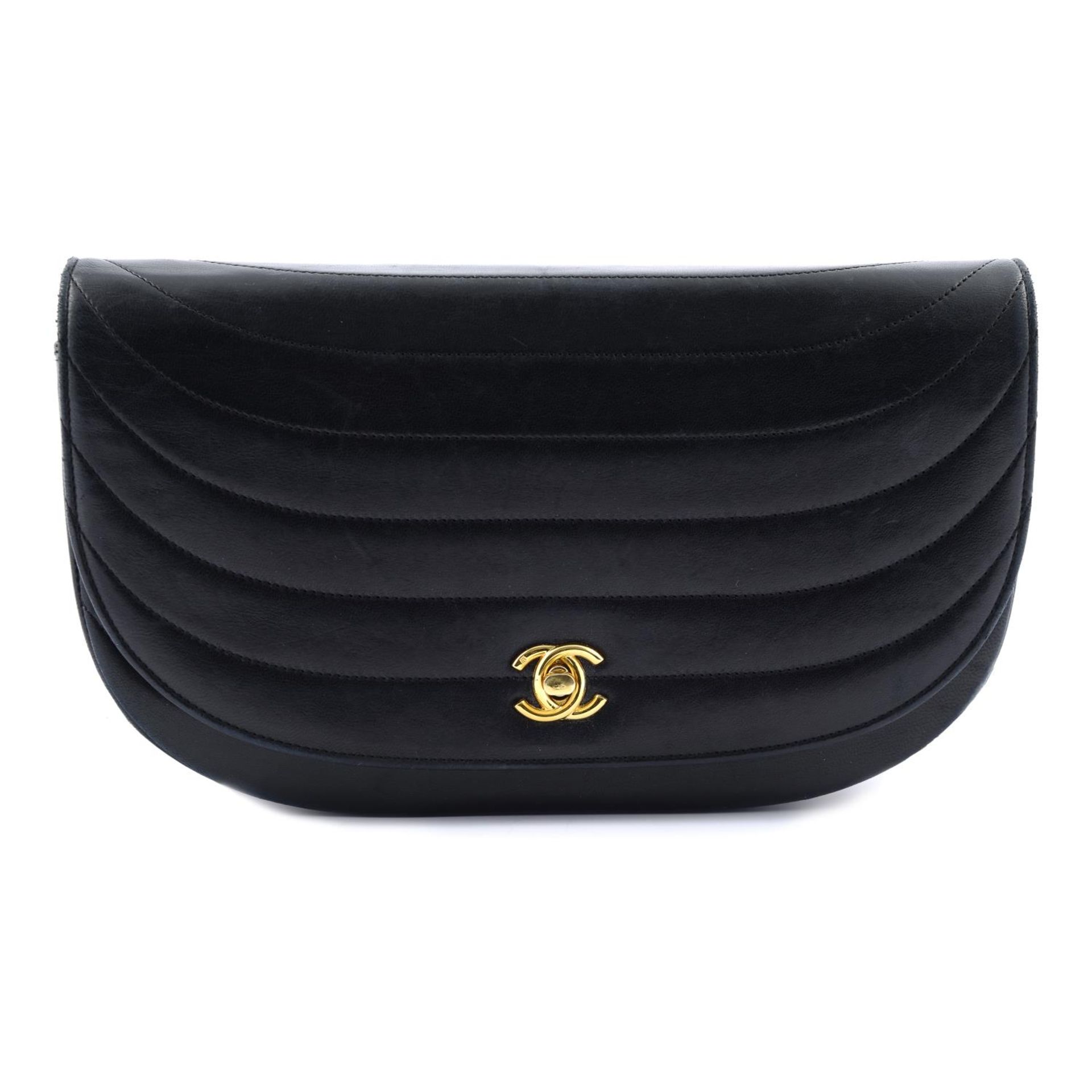 CHANEL - a navy blue leather handbag.