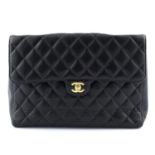 CHANEL - a Jumbo Caviar Classic Flap handbag.