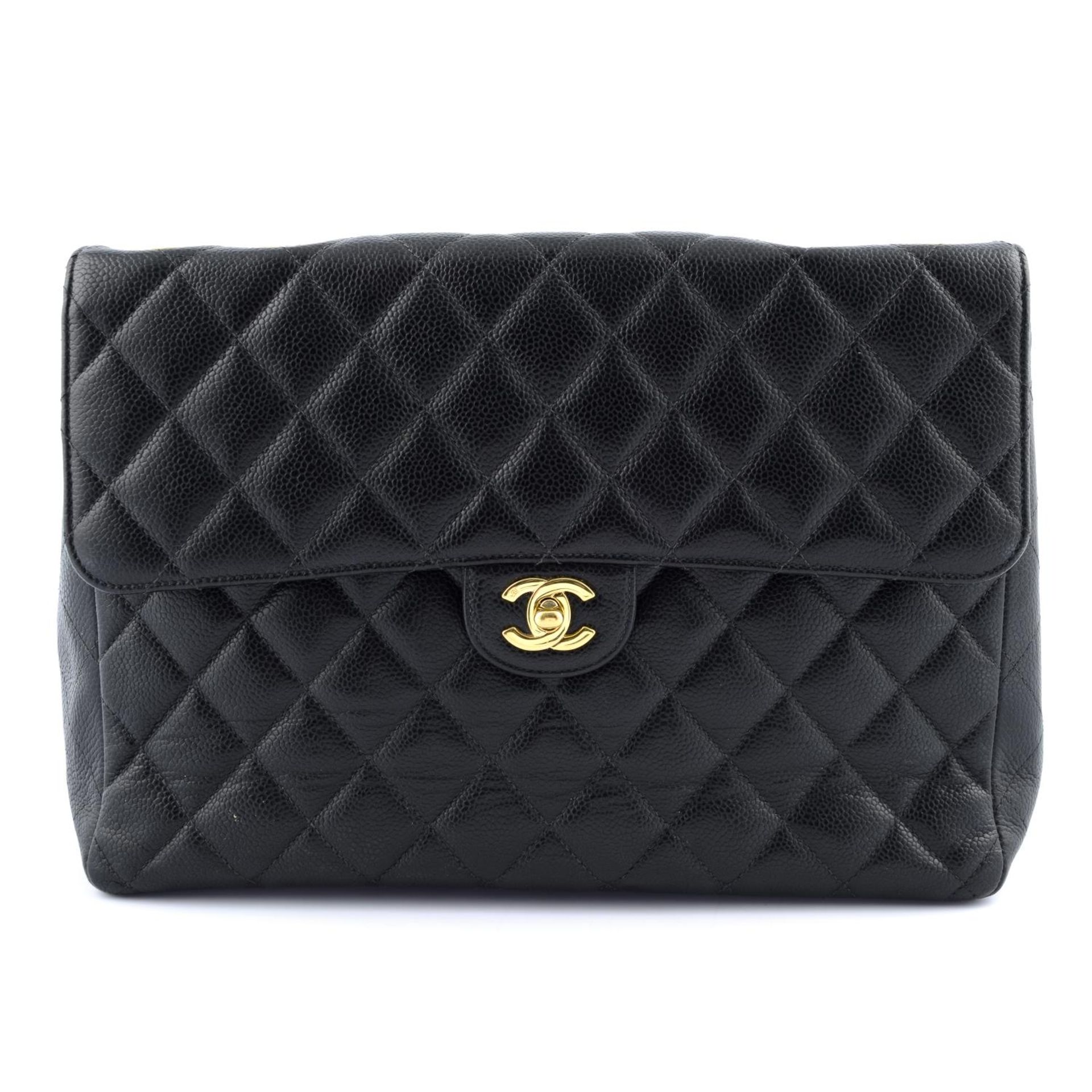 CHANEL - a Jumbo Caviar Classic Flap handbag.