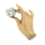 A textured hand holding a brilliant-cut diamond stud.Estimated diamond weight 0.25ct,