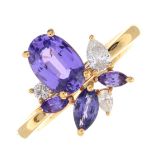 An 18ct gold purple sapphire and vari-cut diamond ring.Estimated total diamond weight 0.15ct,