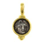 A mounted coin pendant.Stamped 19K.Length 3.9cms.