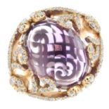 An 18ct gold amethyst and brilliant-cut diamond dress ring.Amethyst weight 8cts.Total diamond