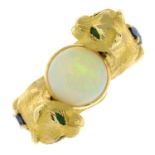 A ring, designed as two gem-set cats, holding an opal cabochon.