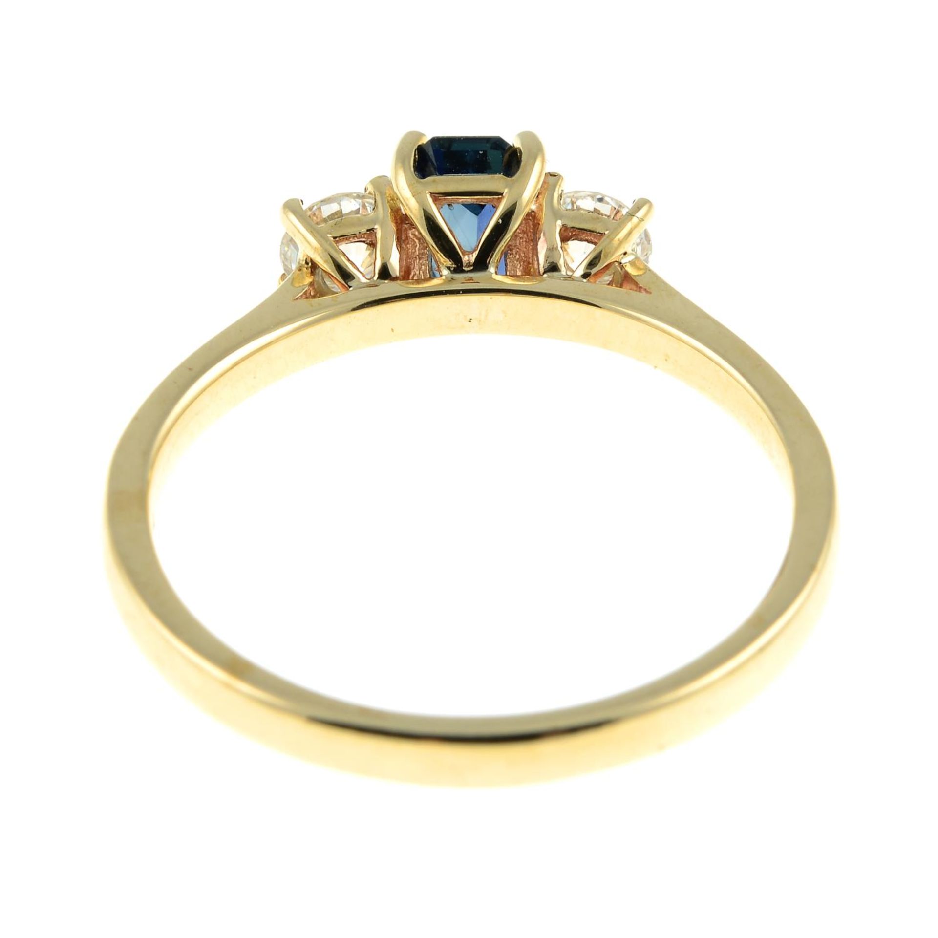 A 9ct gold sapphire and brilliant-cut diamond three-stone ring.Sapphire calculated weight 0.64ct, - Image 2 of 3