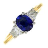 A sapphire and diamond three-stone ring, with diamond accent gallery.