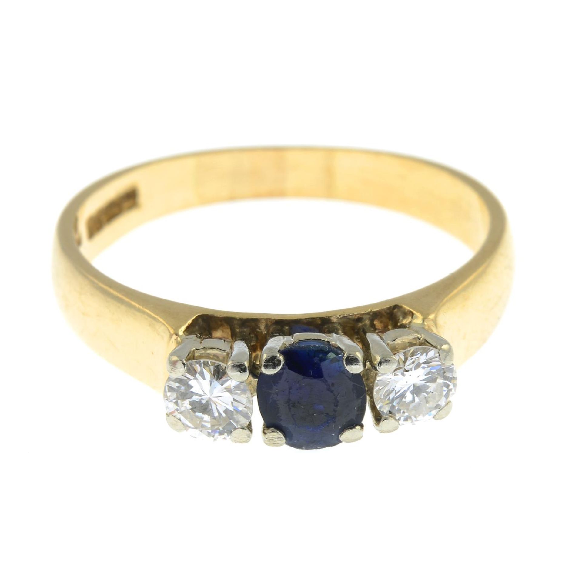 A 9ct gold sapphire and brilliant-cut diamond three-stone ring.Estimated diamond weight 0.40ct,