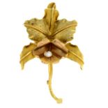 A textured leaf brooch, with cultured pearl accent.Stamped 18K.Length 8cms.