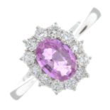 An 18ct gold pink sapphire and brilliant-cut diamond cluster ring.Pink sapphire weight 0.94ct.