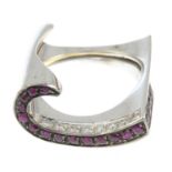 An 18ct gold ruby and brilliant-cut diamond scroll ring.Estimated total diamond weight 0.30ct.